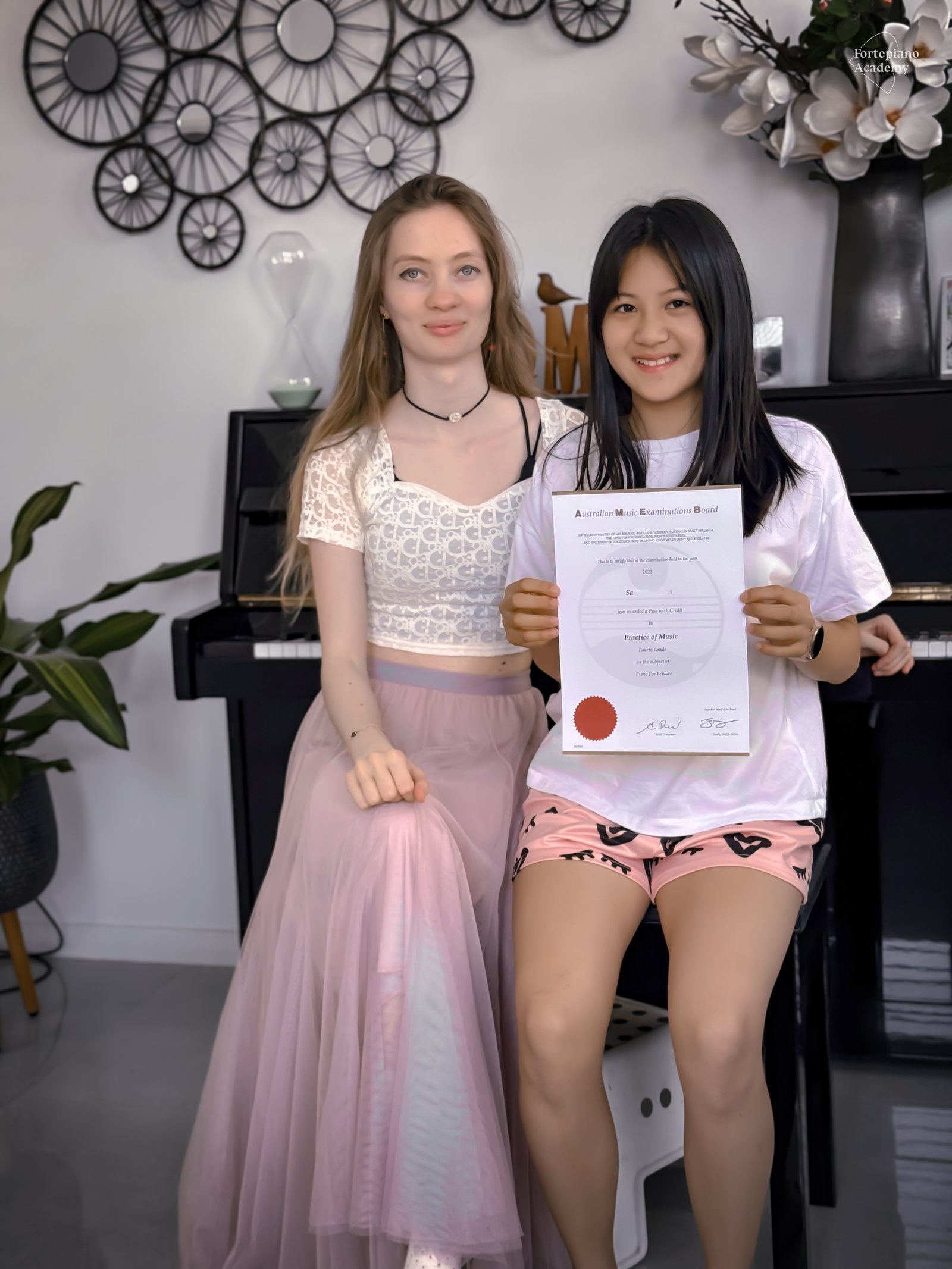 Fortepiano Academy teacher and student holding a certificate